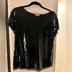 Fun and sparkly black sequin short-sleeved shirt.